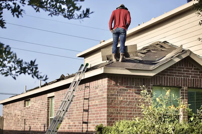 Professional roofer working on a residential roof in Lexington Farms